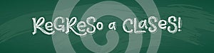 Spanish Back to School text drawing by white chalk on Green Chalkboard. Education vector illustration horizontal banner.