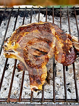 Spanish beef Chuleton on the charcoal bbq. photo