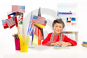 Spanish boy learning geography sitting at the desk