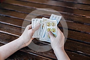 Spanish boy Playing cards. Close up of hands