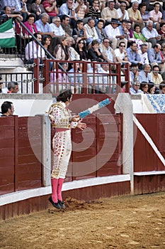 Spanish bullfighter Juan Jose Padilla jumping and suspended in the air with two banderillas in the right hand looking at the bull
