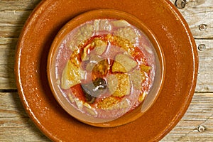 Spanish callos in an earthenware dish on a wooden table