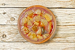 Spanish callos in an earthenware dish on a wooden table