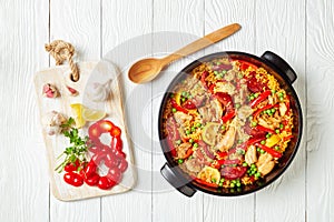 Spanish chicken paella in a black dish