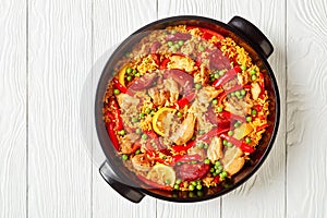 Spanish chicken paella in a black dish