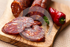 Spanish chorizo sausage with parsley on rustic boa