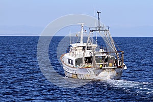 Trawler fishing boat ready to use nets. photo