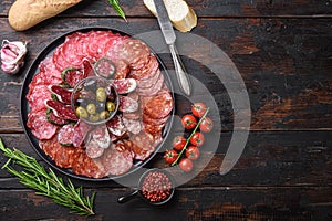 Spanish cold meat plate, chorizo, fuet, lomo,longaniza and salchichon  on wooden table, top view with copy space