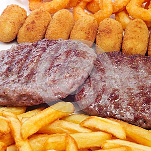Spanish combo platter with burgers, croquettes, calamares and fr photo