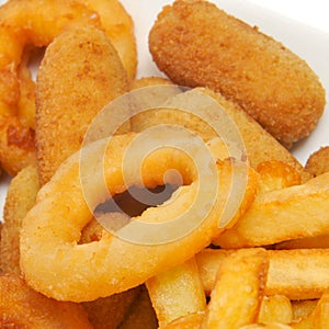 spanish combo platter with croquettes, calamares and french fries photo