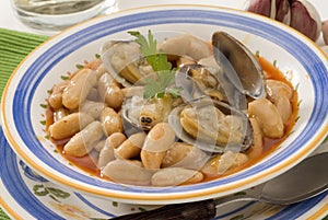 Spanish Cuisine. Asturian clams and beans. photo