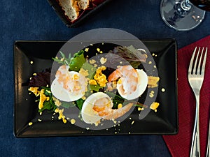 Huevos mimosa con gambas, eggs with prawns and salad photo