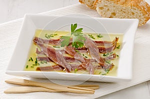 Spanish Cuisine. Marinated anchovies. Anchoas en aceite. photo