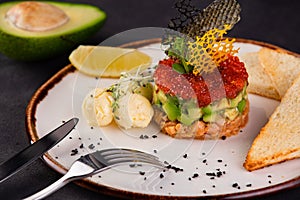 Spanish cuisine, tartarus from red fish, Red caviar and avocado