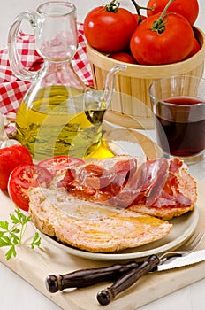 Spanish Cuisine. Tomato bread and Serrano Ham. Pa amb tomaquet i photo