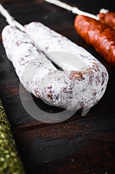 Spanish dry fuet sausages on wooden surface
