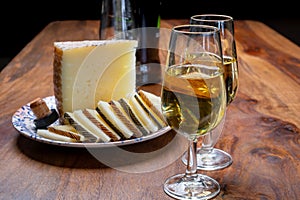 Spanish fino sherry wine from Andalusia and pieces of different sheep hard manchego cheeses made in La Mancha, Spain. Wine and photo