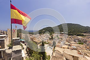 Spanish flag flying above the town of Capdepera on Majorca