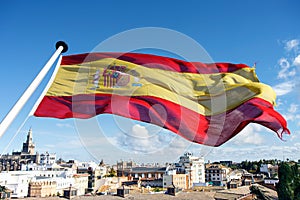 Spanish flag flying over city of Seville