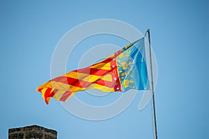 Spanish flag over the tower on blue sky