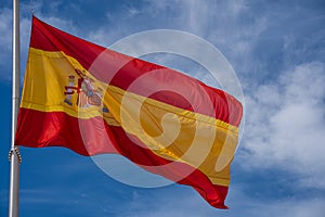 Spanish flag waving against the blue sky
