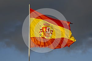 Spanish flag Waving in the Wind with Blue Sky and Clouds Cadiz Andalusia
