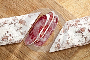 Spanish fuet salami cuts on wooden board