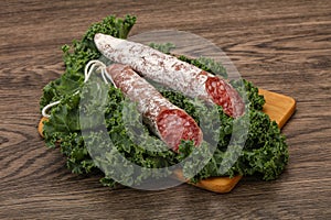 Spanish Fuet sausage with salad leaves