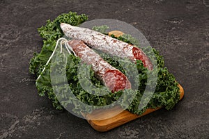 Spanish Fuet sausage with salad leaves