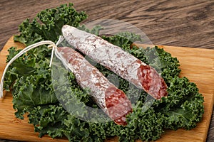 Spanish Fuet sausage with salad leaves