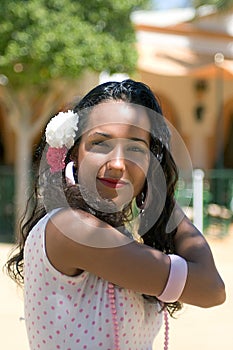 Spanish Girl in Feria Dress adjusts hair photo