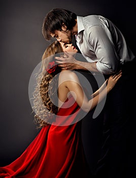 Spanish Girl. Woman in Red Dress with Boyfriend side view Kiss. Valentines Day