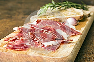 Spanish ham with toasts as background