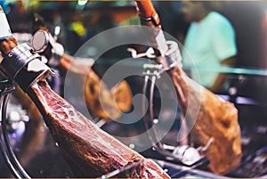 Spanish hamon in barcelona market, jamon iberico in view black leg pork , traditional national spain meat in store, serran