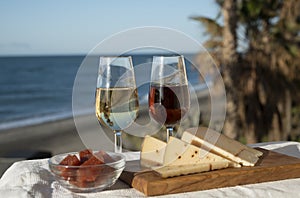 Spanish hard Andalusian cheese filled with sweet sherry served outdoor with membrillo jam with two glasses of sherry wine with