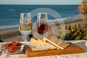 Spanish hard Andalusian cheese filled with sweet sherry served outdoor with membrillo jam with two glasses of sherry wine with