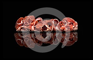 Spanish jamÃ³n on a black background with its reflection as a mirror photo