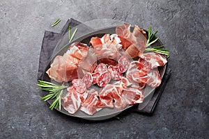 Spanish jamon, prosciutto crudo ham, italian salami photo
