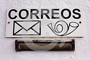 Spanish Mailbox. The sign on the white wall. photo