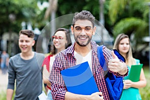 Spanish male student with group of other students