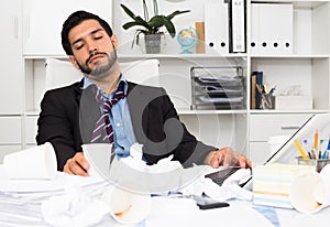 Spanish man is sleeping at desk after productive day