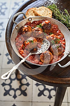 Spanish meatballs in a spicy tomato sauce photo