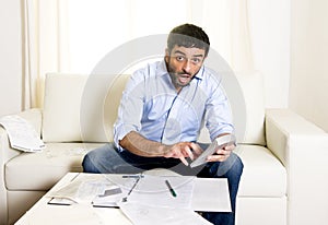 Spanish mexican business man worried paying bills on couch