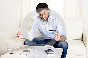 Spanish mexican business man worried paying bills on couch