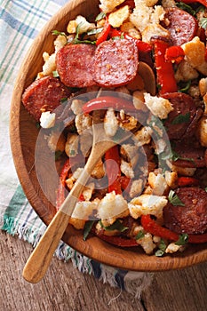 Spanish migas close-up on a plate. vertical top view