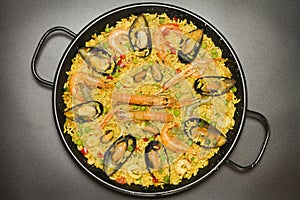 Spanish paella on black background