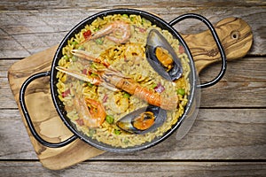 Spanish paella on a wooden table