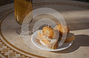 Spanish pincho of croquettes close to glass of beer