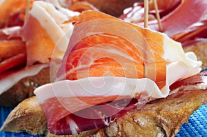 Spanish pinchos de jamon, serrano ham served on bread