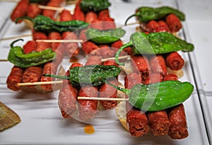 Spanish pintxos of sausages with peppers in a Basque bar, San Sebastian, Spain